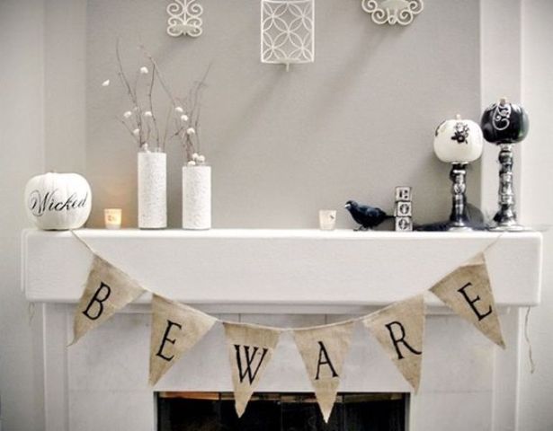 25-white-halloween-mantel-decor-with-a-banner-and-several-pumpkins-on-stands
